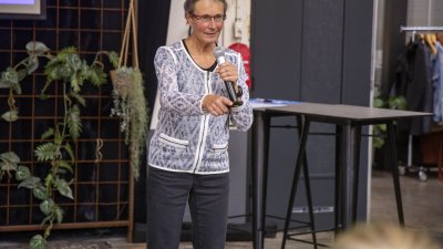 Katja Staartjes wijst naar de zaal tijdens haar lezing